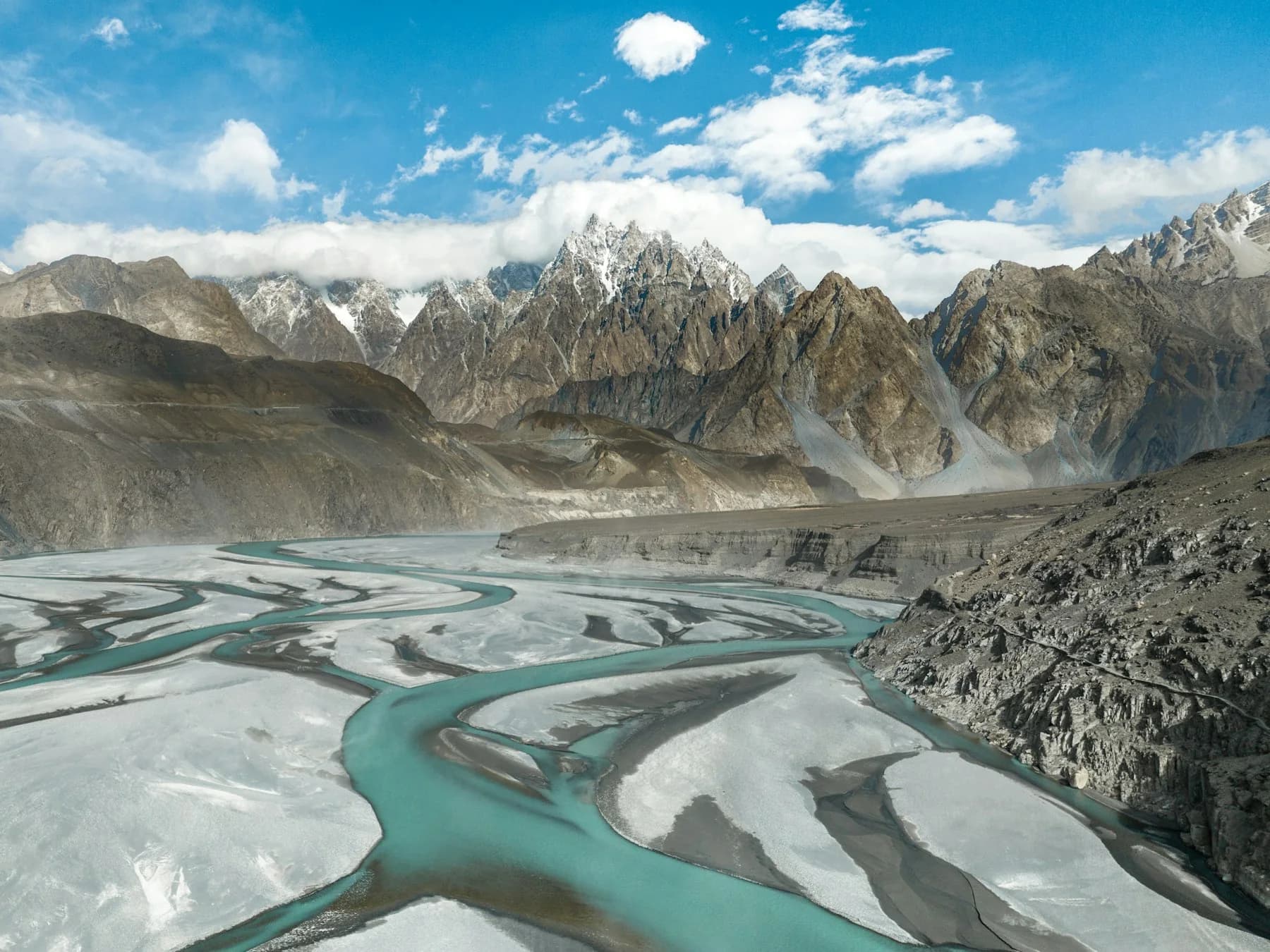 A glacial river and high Karakoram peaks in Hunza Valley.